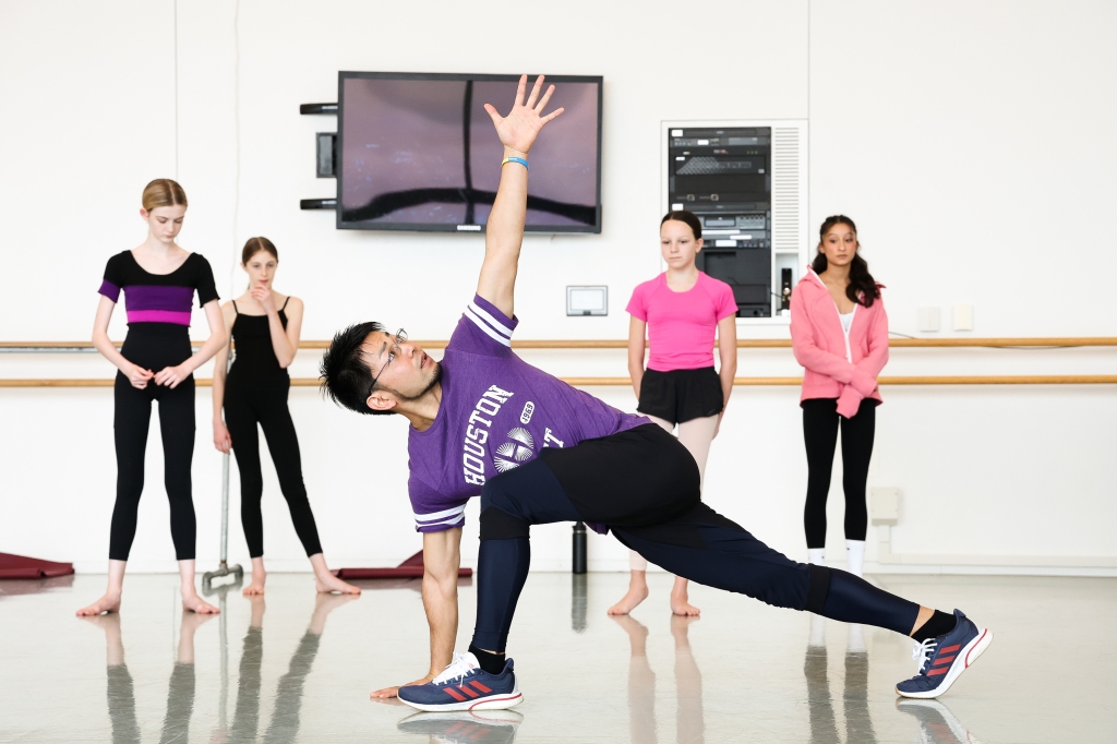 Houston Ballet Head Strength and Conditioning Coach Aki Kawaskai with students of Houston Ballet Academy. Photo by Lawrence Elizabeth Knox (2023). Courtesy of Houston Ballet.